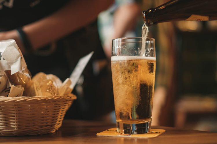 beer being pored into a glass