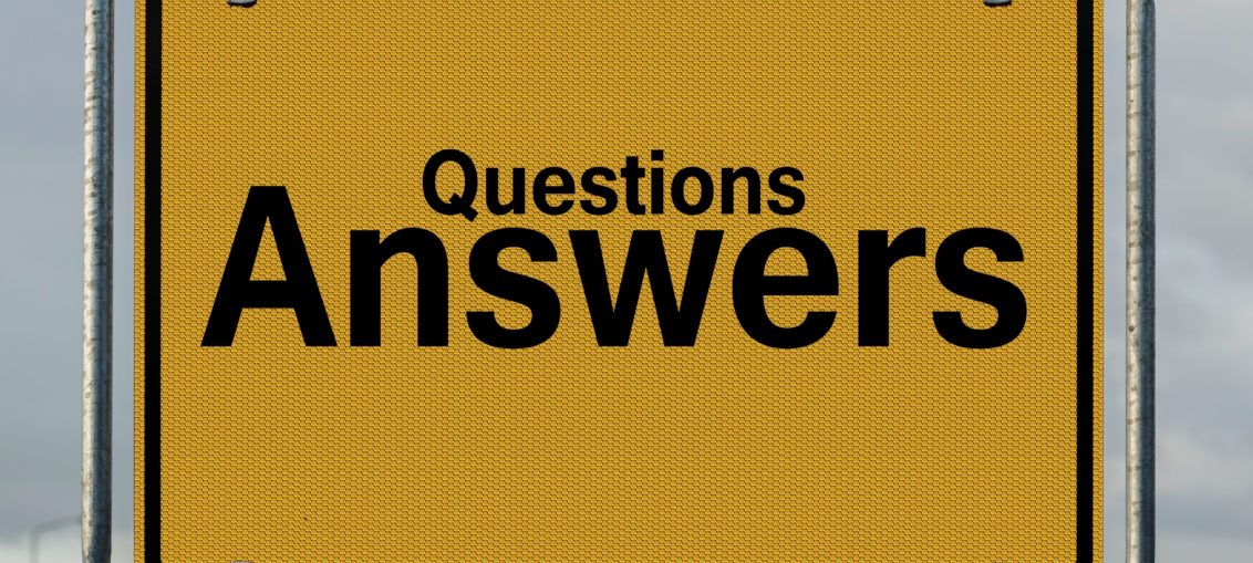 A yellow highway sign reads "Questions Answers"