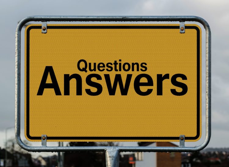 A yellow highway sign reads "Questions Answers"