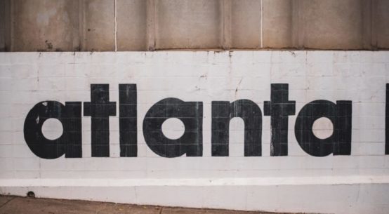The word Atlanta is seen painted on a wall