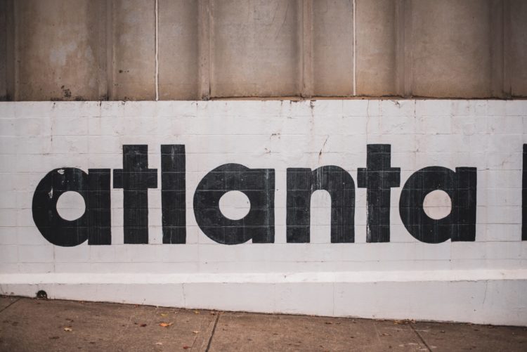 The word Atlanta is seen painted on a wall